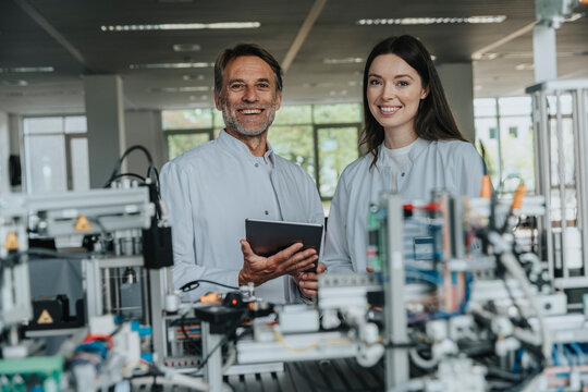 Scientists analyzing data with sorting machine in laboratory