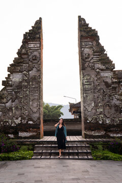 Traveler standing at ancient temple gate in Bali outdoors
