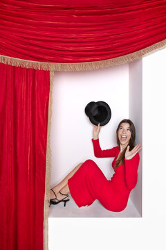 Surprised girl with magic hat sitting in alcove