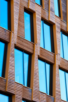 Sustainable urban scandinavia residential architecture highlights modern wood timber facade and windows with daylight texture detail and design character