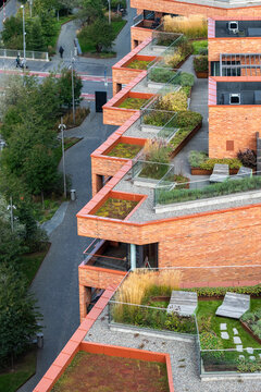Sustainable urban scandinavia residential architecture features green rooftop gardens and terraces creating modern daylight ecology above the city