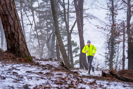 Trail running training in snowy Haselstein forest in Remstal Germany