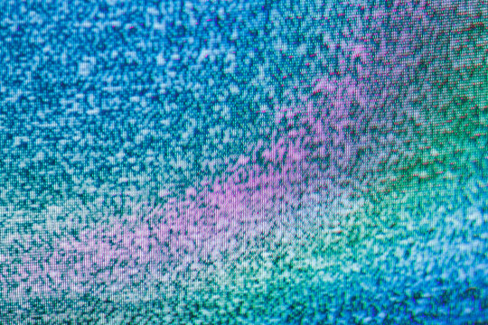 Abstract crt tv static close-up with vivid diagonal pink magenta band on blue teal pixel background