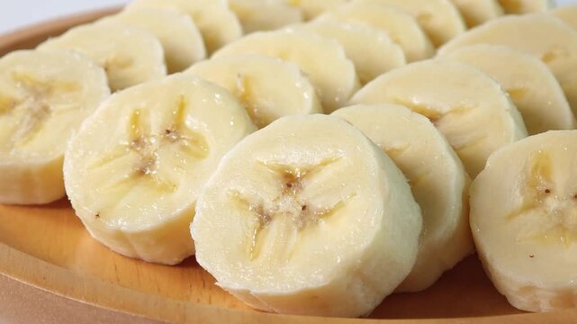 close-up captures the creamy allure of sliced bananas. Each uniform piece unveils a soft	