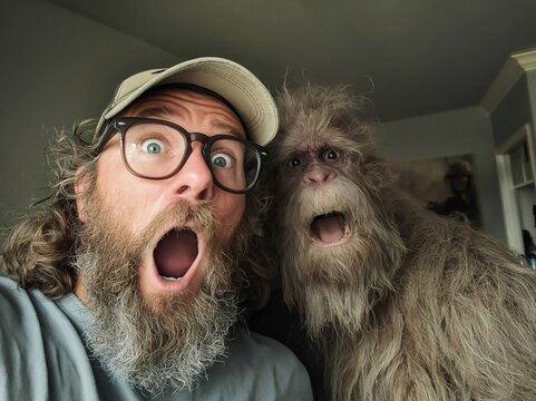 Funny selfie of surprised man with ape-like creature