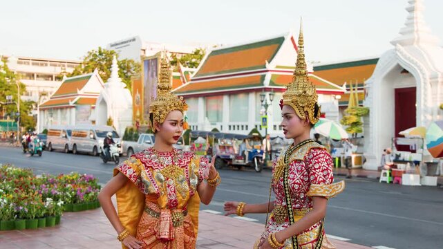 Two Thai Khon Dancers in Traditional Costumes Perform Outside Wat Suthat