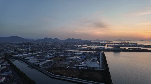 Marugame, Japan: Panoramic footage of dramatic sunset over coastal port and city of Marugame facing the Inland sea in Kagawa Prefecture in Japan