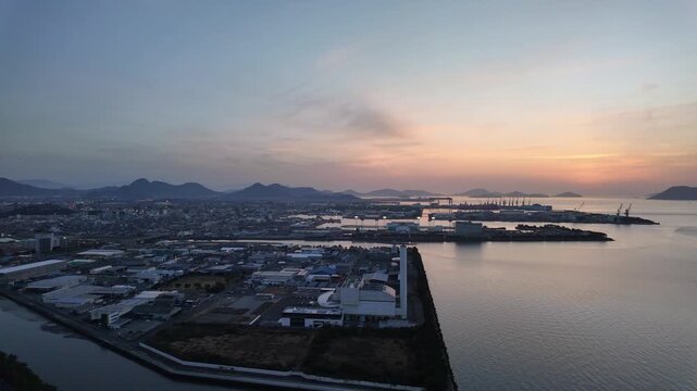 Marugame, Japan: Panoramic footage of dramatic sunset over coastal port and city of Marugame facing the Inland sea in Kagawa Prefecture in Japan