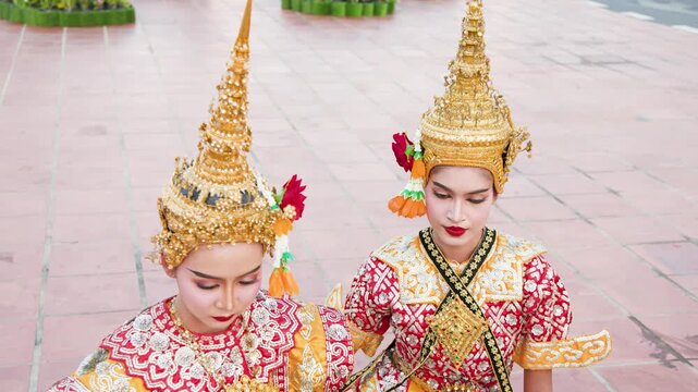 Two Thai Khon Dancers in Traditional Gold Headdresses and Costumes