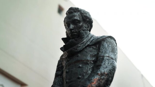 A statue of the Russian writer Alexander Sergeyevich Pushkin standing on the street close-up.