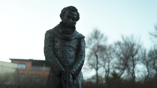 A statue of the Russian writer Alexander Sergeyevich Pushkin standing on the street close-up.