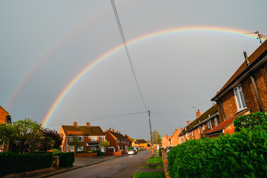 Double rainbow on a gray sky after rain and storm. Real rainbow after rain on a spring day.