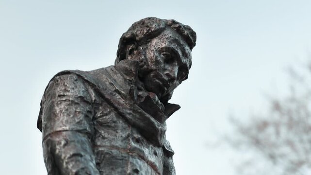 A statue of the Russian writer Alexander Sergeyevich Pushkin standing on the street close-up.