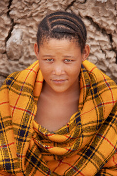Basarwa San Woman Portrait Kalahari with a slight smile against a blurred natural background.