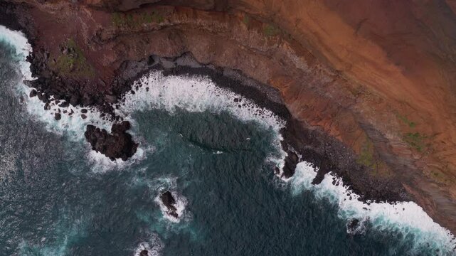 Aerial view of dramatic coastal cliffs and waves in Madeira
