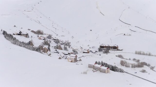 Las Le&ntilde;as ski resort village in Malarg&uuml;e Mendoza Argentina featuring Hotel Piscis Hotel Acuario and Hotel Escorpio along Ruta Provincial 222 in Valle de Las Le&ntilde;as, snow covered Andes valley, aerial