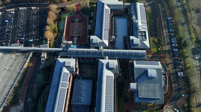High altitude drone shot of the intricate glass and steel architecture of the National Grid office building in Warwickshire UK.