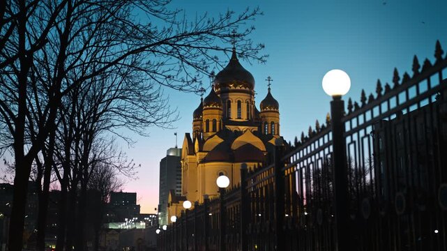 Russian orthodox church gleaming against a vibrant blue sky, showcasing religious architecture and cultural heritage in Vladivostok at night in darkness.