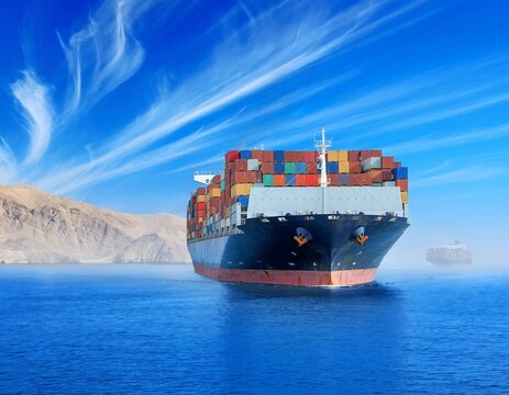 Large Cargo Ship Sailing on the Ocean Under a Blue Sky.