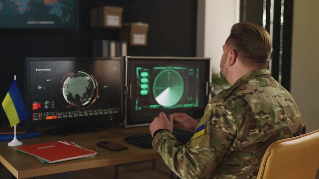 Ukrainian male service member planning response using intelligence data systems