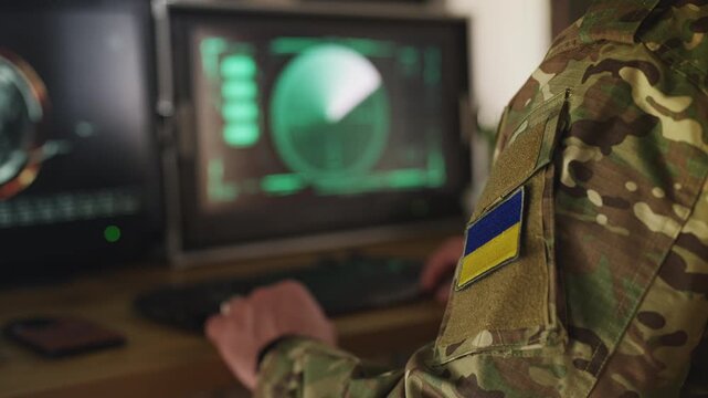 Ukrainian air defense officer gathering satellite data, managing defense systems
