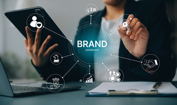 Brand awareness strategy concept, businessman touch digital brand awareness icons, communication, target, Marketing growth, customer loyalty, and partnership symbols for corporate branding success