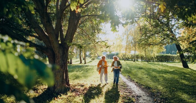 Senior women walking in park enjoying autumn nature