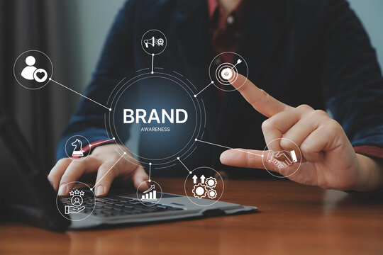 Brand awareness strategy concept, businessman touch digital brand awareness icons, communication, target, Marketing growth, customer loyalty, and partnership symbols for corporate branding success