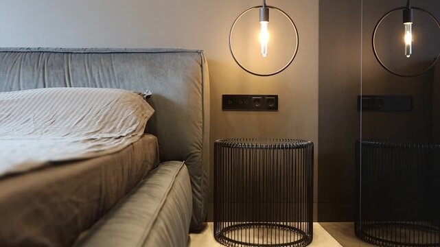 Snug bedroom setting illuminated by filament bulb and cozy accessories