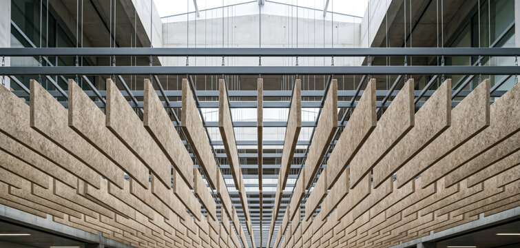 Suspended jute acoustic baffle ceiling system with repeating panels in a commercial interior