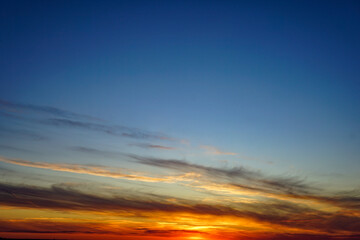 Fototapeta premium A dramatic sunset in a sky of bright orange and red hues
