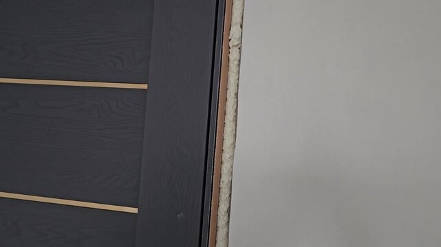 Door installation process in a modern home in the afternoon showing steps to fit door properly