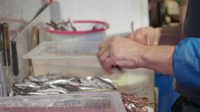 Preparing fish at a market in the afternoon
