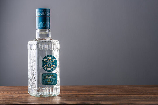 Bottle of silver  tequila on wooden table