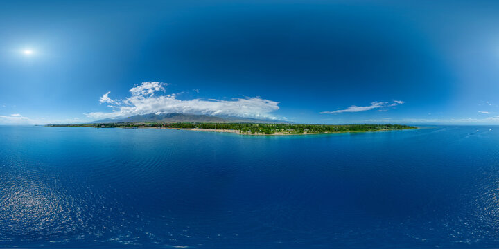 Aerial 360 degrees view of Issyk-Kul lake coastline with boats and calm water