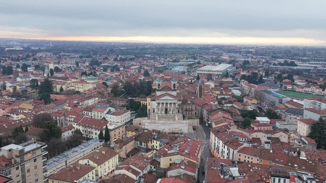 Aerial drone footage featuring a smooth approaching movement combined with rotation toward the Duomo di San Pietro Apostolo in Schio, Italy