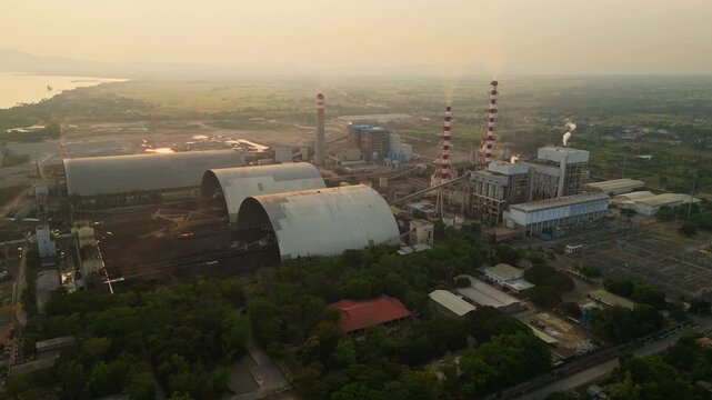Orbit Rotation Shot showing the view from above of Calaca powerplant on a smooth circular drone movement around smokestacks