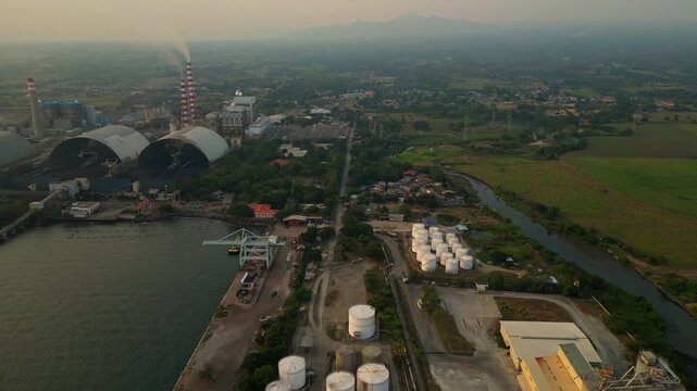Calaca Powerplant Batangas Philippines &mdash; top aerial view of industrial power plant during sunset with smoke emissions showing overall production.