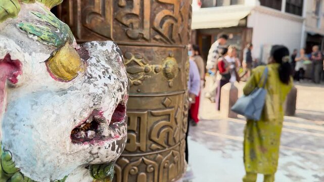 Stone Lion Statue and Brass Prayer Wheel in Kathmandu City, Nepal