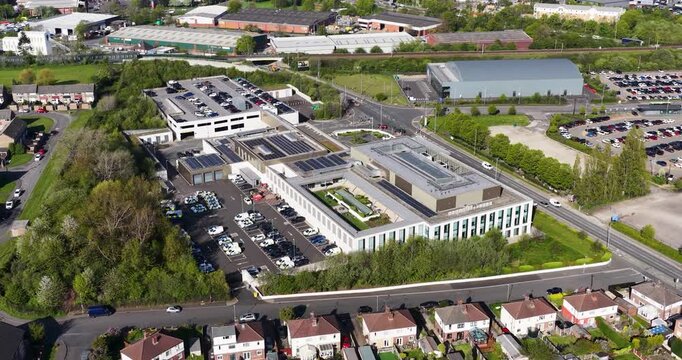 Aerial drone footage of the Police headquarters the city of Leeds west Yorkshire in the UK, showing the new Police station building from above in the spring time surrounded by residential houses