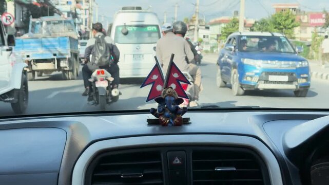 View of Kathmandu Traffic with Ganesha Statue through a Windshield, Nepal