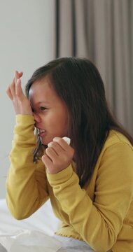 Tissue, relax and child blowing nose in bed for recovery of allergy infection, flu or cold. Sneeze, sick and girl kid with toilet paper in bedroom for healing with illness, sinus or hayfever in house