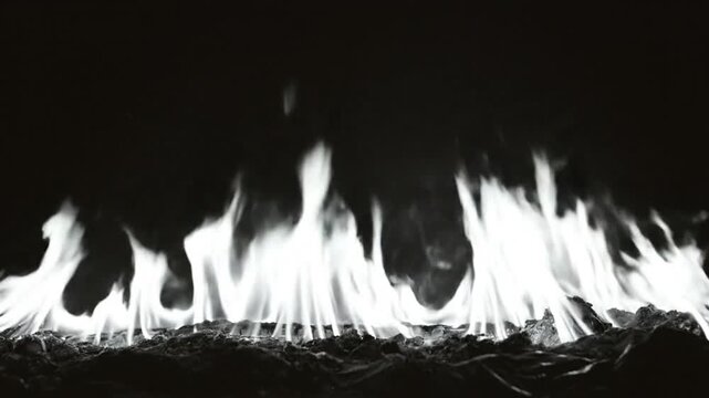 Black and white close up of dancing flames, showcasing mesmerizing, dynamic fire against a dark backdrop