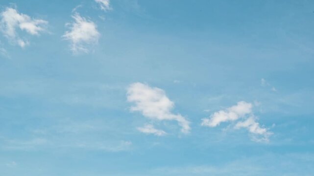 Four frames display different cloud patterns in a bright sky during the day. timelapse