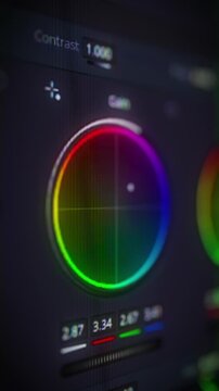 Color correction media post production software. Color grading control panel. Vibrant color wheels and adjustment sliders on monitor screen. Video editing UI. Close up macro