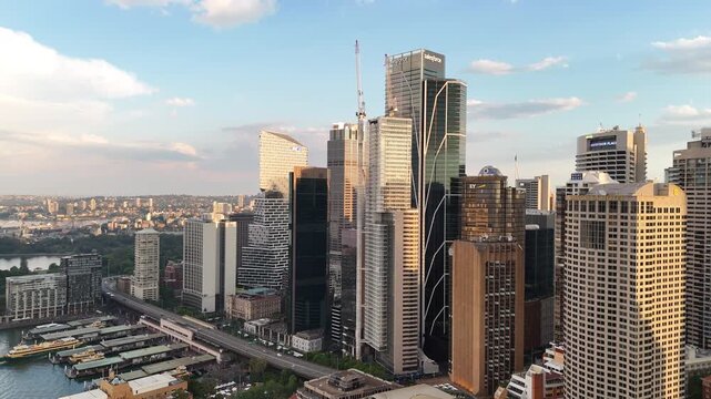 Sydney, New South Wales, Australia - November 20, 2025: Drone footage of Sydney CBD skyline with modern skyscrapers, office towers and urban roads during golden hour.