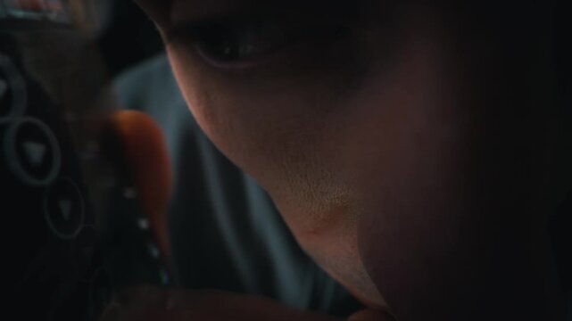 Macro details of a man with his eye closed reveal natural skin texture and small blemishes. Soft lighting emphasizes the pores and facial details during a quiet moment of rest indoors.