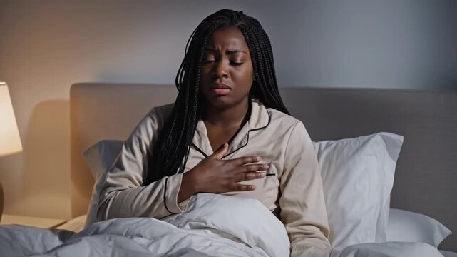 Woman Waking Up with Chest Pain in Bed at Night. 4K Video