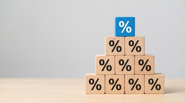 Wooden blocks with percentage symbols are stacked in a pyramid shape with a prominent blue block on top indicating rates or growth