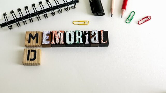 Memorial Day Text on Wooden Blocks with Office Supplies Flat Lay